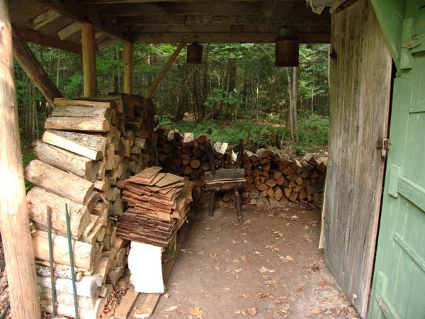 Woodshed with wood restacked.  All the well seasoned wood is most easily accessible now.