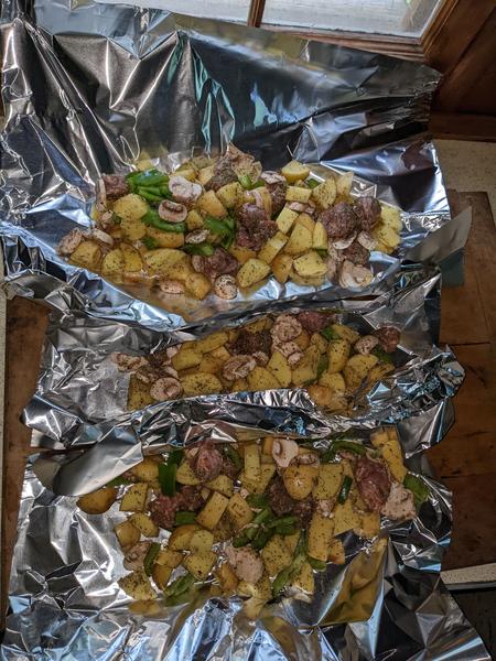 Foil pack dinners ready to be wrapped up for cooking.