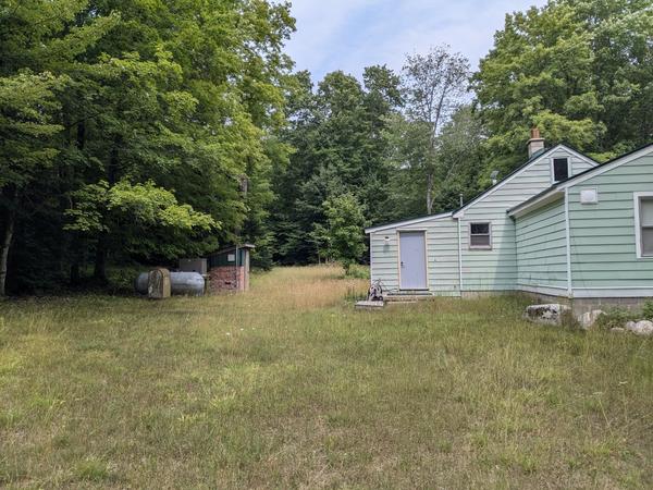 Side view of Camp Harding with the large propane tank and a generator shed(?)
