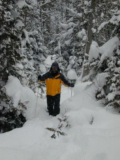 Matt snowshoeing in the woods.