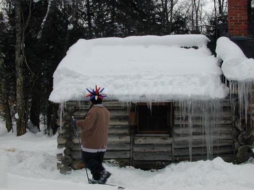Jon snowshoeing past the cabin.