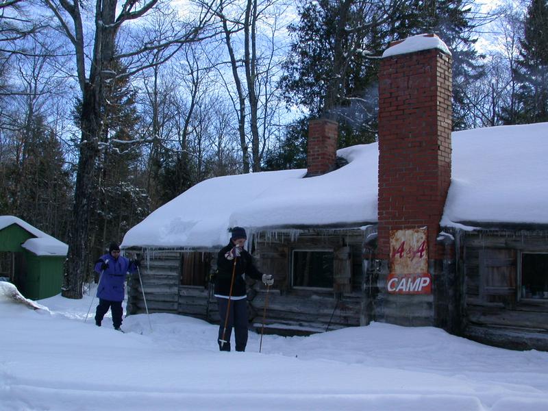 Amelia and Jon leaving the cabin to go skiing.