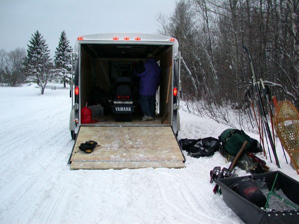 Jon unloading the trailer at the trailhead.  Notice there
	   is actually snow on the ground and it is actually light out!