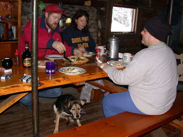 Bill, Vittoria, and Jon having breakfast. Abby
	   hiding under the table.