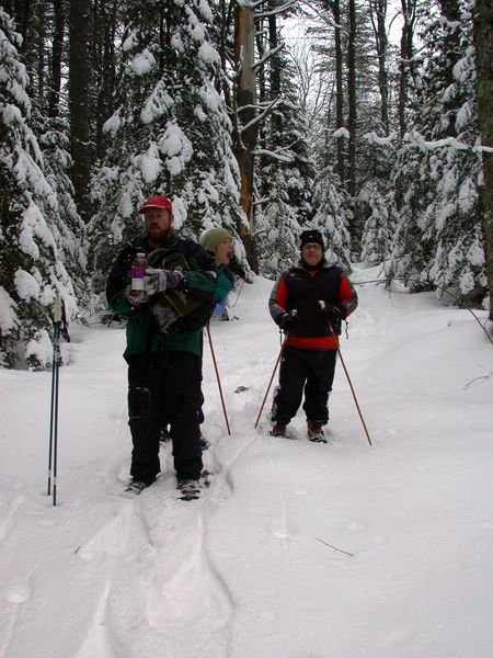 Bill and Jon taking a break while snowshoeing.  Vittoria
		being Vittoria.