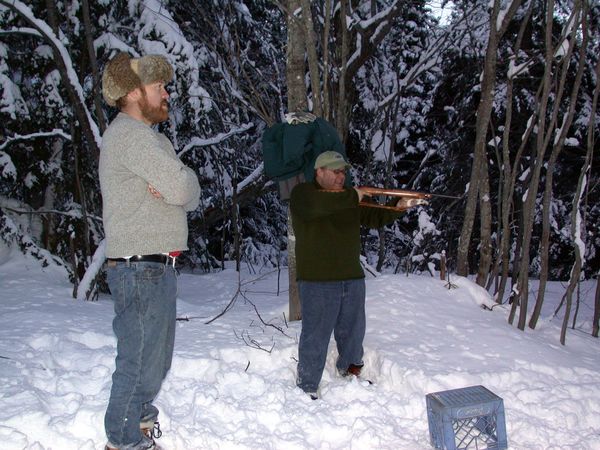 Bill watching Jon shoot the gun.