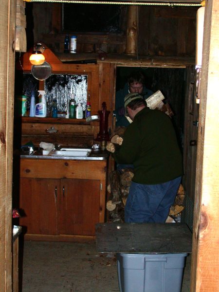 Bill and Jon carrying in wood.