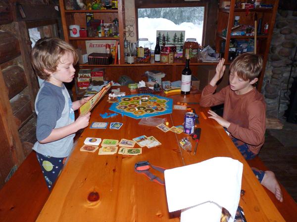 Teddy and Frankie playing Settlers of Catan.