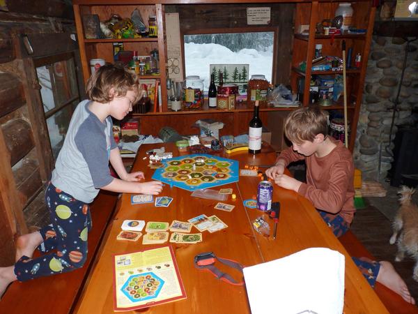 Teddy and Frankie playing Settlers of Catan.