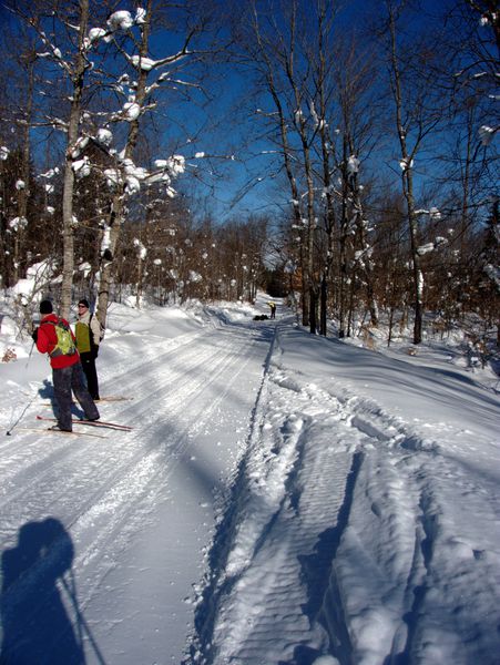 Skiing along Old Seney.Jon down and laughing with Doug in the distance.
