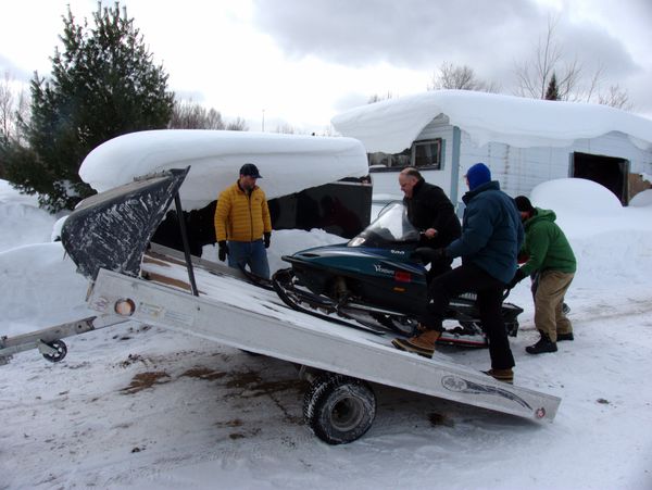 Loading the snowmobiles for the drive home.