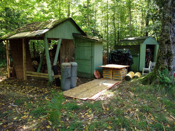 Wood shed with repair supplies.