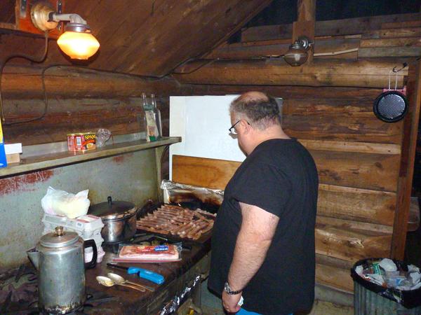 Jon cooking mountains of bacon.