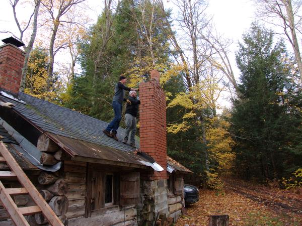 Ed and Andy removing more bricks from the chimney.