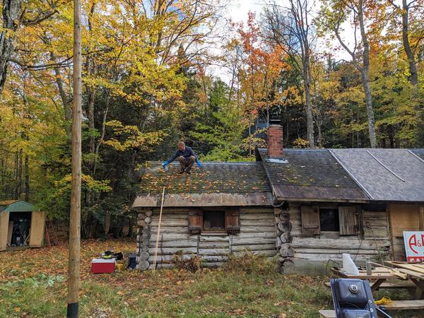 Bill spraying the moss on the roof to remove it.