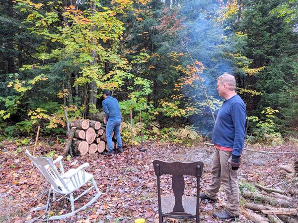 Mikey stacking logs from the downed (huge) tree limb.