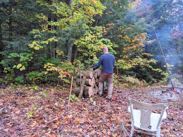 Bill stacking logs from the downed (huge) tree limb.