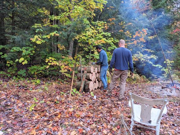 Mikey and BIll stacking logs from the downed (huge) tree limb.