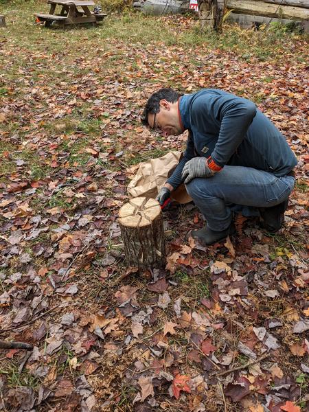 Mikey lighting a Swedish log.