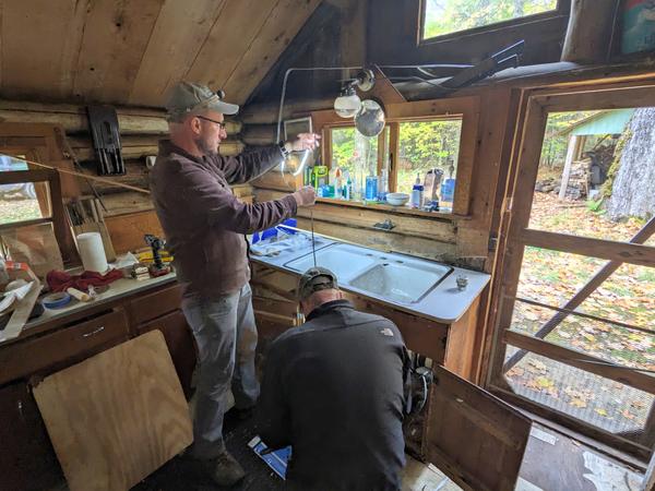 Andy and Bill reattaching the sink in the new countertop.