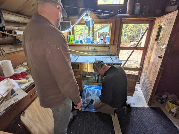 Andy and Bill reattaching the sink in the new countertop.