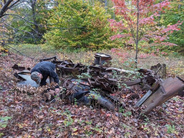 Bill at the site of the ruined trucks.