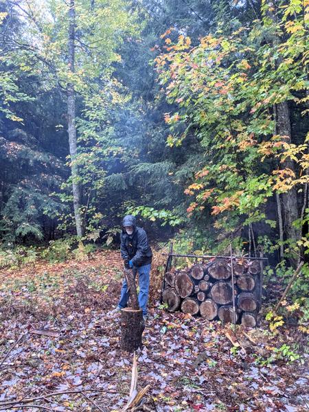 Arthur splitting wood from the downed tree limb.