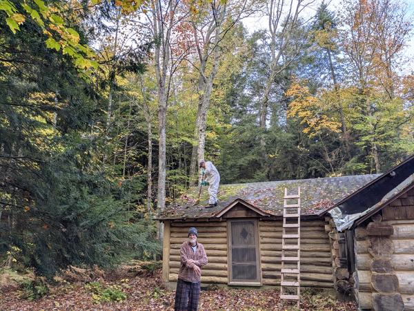 Arthur with Bill on the roof cleaning off moss.