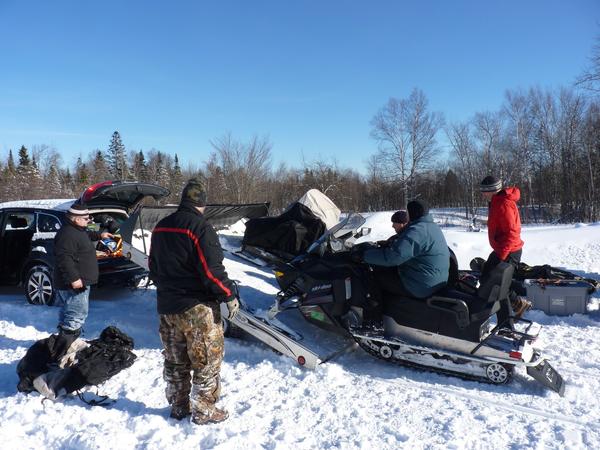 Loading the snowmobiles onto the trailer.