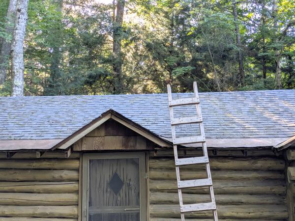One side of the bunk house roof with moss brushed off of all of it.
