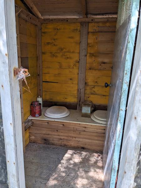 Inside view of the two seater outhouse (still in excellent condition) at the ruined camp site off of McCloud Grade.