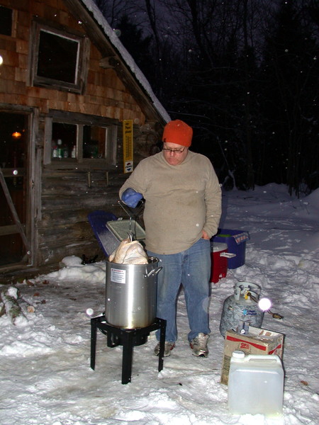 Jon putting the turkey in the deep fryer.