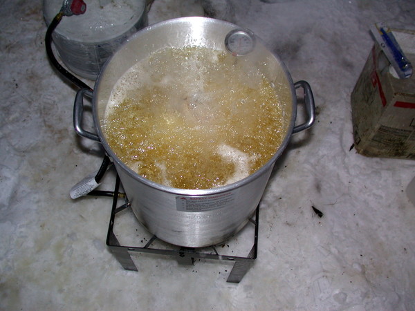 The turkey cooking in the deep fryer.