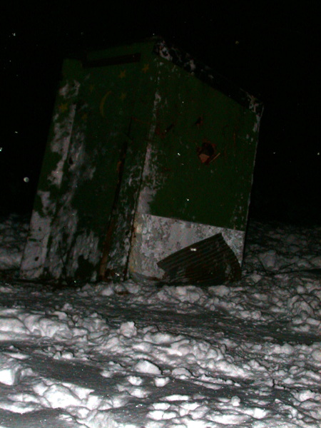 Old outhouse with coals from the fire just put in.