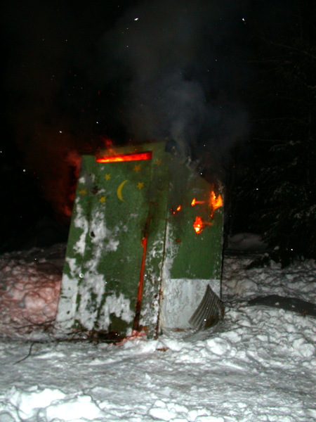 The old outhouse starting to burn.